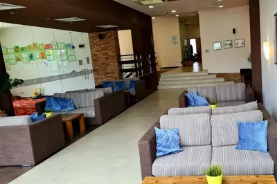 a lobby with couches and blue pillows at Aspen Golf Resort and SPA in Bansko