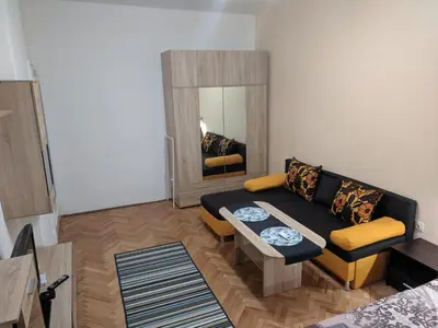a living room with a couch and a table at Convenient New Apartment Near Metro Station by Flat Mаnager in Sofia