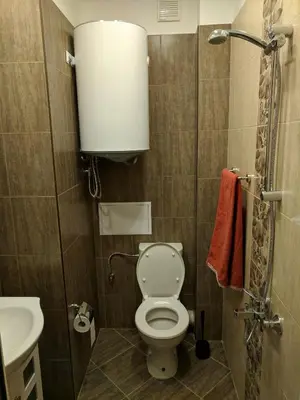 a small bathroom with a toilet and a sink at Convenient New Apartment Near Metro Station by Flat Mаnager in Sofia