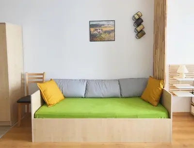 a couch in a living room with yellow and gray pillows at Aspen studio Mountain retreat at Aspen Resort Golf Ski & Spa in Razlog