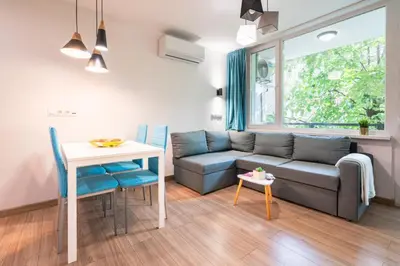 a living room with a couch and a table at Modern and Cozy 1BDR Apartment in the City Center in Sofia