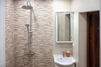a bathroom with a shower and a sink at Modern and Cozy 1BDR Apartment in the City Center in Sofia