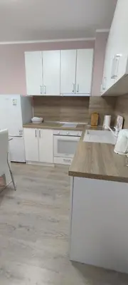 a kitchen with white cabinets and a counter top at Luxury and stylish apartmen, metro station Obelya in Sofia
