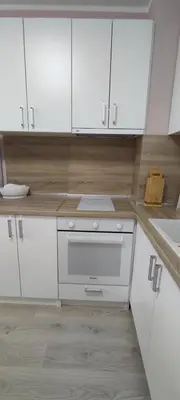 a white kitchen with white cabinets and a sink at Luxury and stylish apartmen, metro station Obelya in Sofia