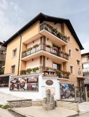 a building with flower boxes on the balconies of it at Beluga Guest House in Velingrad