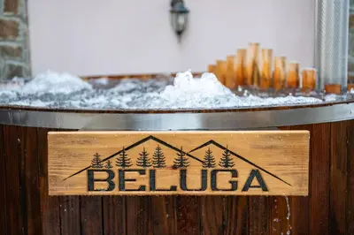 a sign that says beluga in front of a table of snow at Beluga Guest House in Velingrad