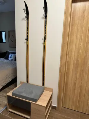 a room with two sets of skis on a wall at Borovets Gardens Studio Raya in Borovets