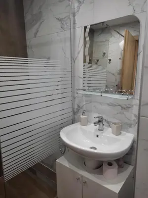a white bathroom with a sink and a mirror at Borovets Gardens Studio Raya in Borovets