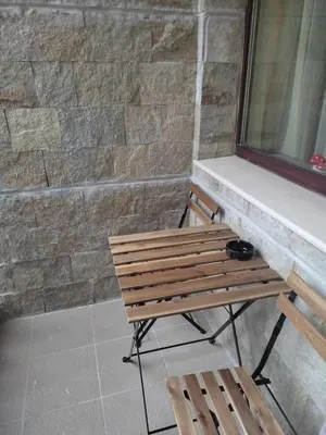 a wooden bench sitting next to a window at Borovets Gardens Studio Raya in Borovets