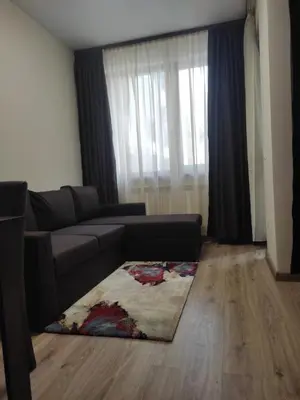 a living room with a couch and a rug at Borovets Gardens Studio Raya in Borovets