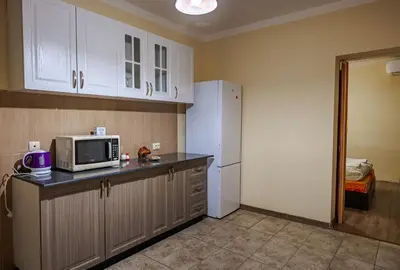a kitchen with a microwave and a refrigerator at ApartmentDanny in Hisarya