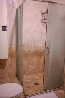 a shower stall with a toilet in a bathroom at ApartmentDanny in Hisarya