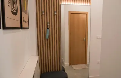 a hallway with a wooden door in a room at Top Center Designer Studio Apartment in Sofia