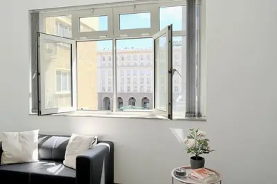 a living room with a couch and a window at Cozy 2-Bedroom Flat in the very Center of Sofia in Sofia