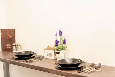 two frying pans sitting on a table with utensils at Cozy 2-Bedroom Flat in the very Center of Sofia in Sofia