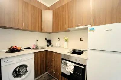 a kitchen with a washer and a white appliance at Cozy 2-Bedroom Flat in the very Center of Sofia in Sofia