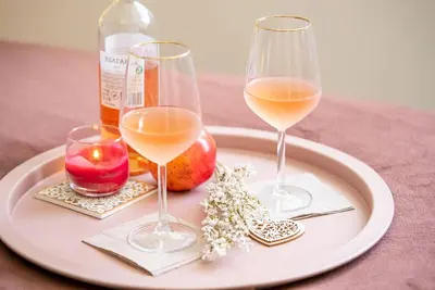 a plate with two wine glasses and a bottle of wine at Cozy 2-Bedroom Flat in the very Center of Sofia in Sofia
