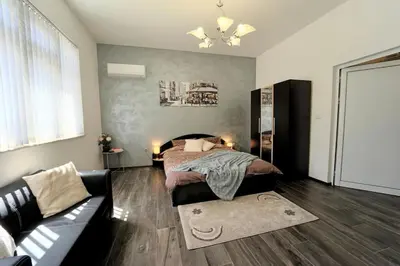 a bedroom with a bed and a couch at Cozy 2-Bedroom Flat in the very Center of Sofia in Sofia
