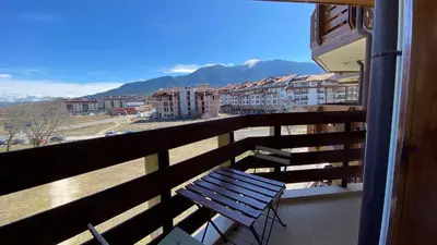 a balcony with a bench and a view of a city at Belvedere Holiday Club H62 Mountains View in Bansko