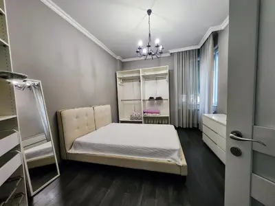 a small bedroom with a bed and a mirror at Doctors Garden Appartment in Sofia