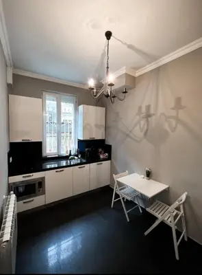 a kitchen with a table and chairs in a room at Doctors Garden Appartment in Sofia