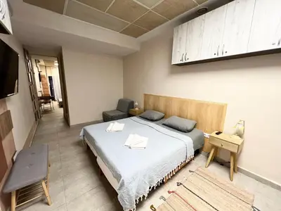 a bedroom with a bed and a table and a chair at Time Traveling Apartment Sofia Mladost District in Sofia