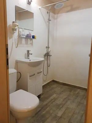 a bathroom with a toilet and a sink and a shower at Time Traveling Apartment Sofia Mladost District in Sofia