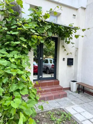 a building with a door with a bench in front of it at Time Traveling Apartment Sofia Mladost District in Sofia