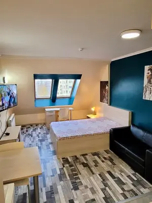 a bedroom with a bed and a couch and a tv at Romantic Studio in Sofia