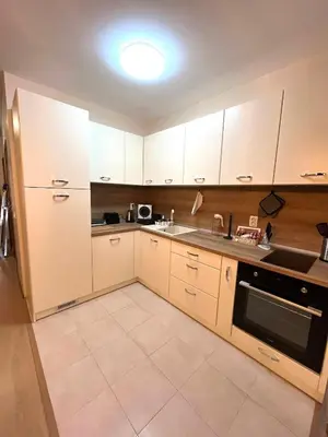 a kitchen with white cabinets and a sink and a stove at Апартамент Ренета Apartment Reneta in Velingrad