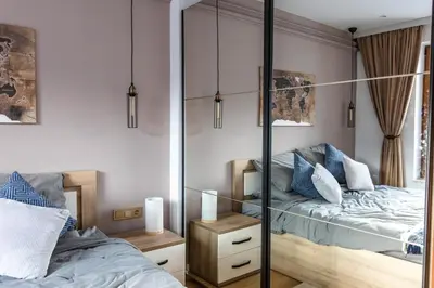 a bedroom with a bed and a mirror at Modern Mountain Getaway in Bansko