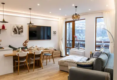 a living room with a couch and a table at Modern Mountain Getaway in Bansko