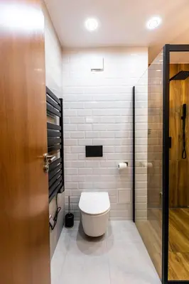 a bathroom with a toilet and a glass door at Modern Mountain Getaway in Bansko