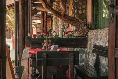 a restaurant with a table with a red table cloth at Safari Village Velingrad in Velingrad