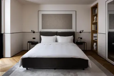 a bedroom with a large bed with white sheets at Juno Hotel Sofia, a Member of Design Hotels in Sofia