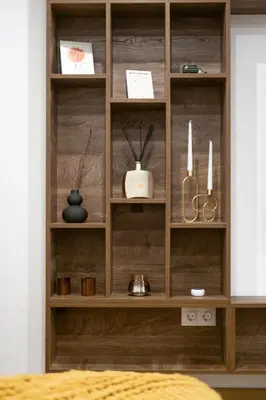 a wooden book shelf in a room at Лиловата Къща in Kalofer
