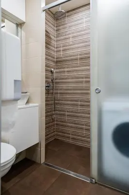 a bathroom with a shower and a toilet at Luxury Studio Silver by Flat Mаnager in Sofia