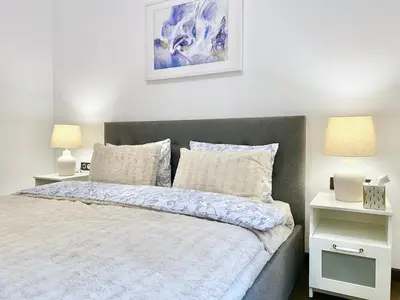 a bedroom with a bed with two night stands and two lamps at Vintage Top Centre Apartment in Sofia