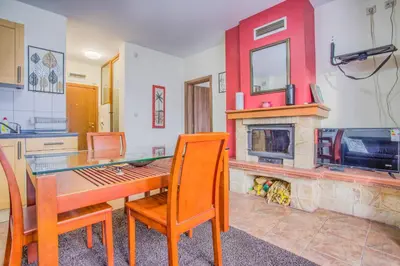 a kitchen with a dining table and a fireplace at Charming Flat in Bansko with Sauna by Flat Mаnager in Bansko