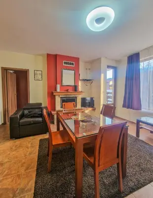 a living room with a dining room table and chairs at Charming Flat in Bansko with Sauna by Flat Mаnager in Bansko