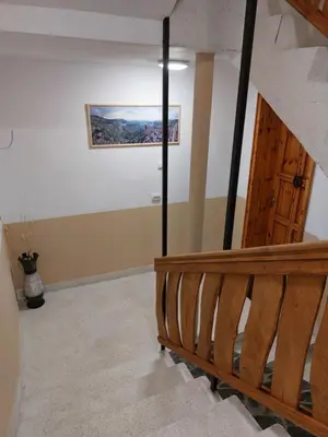 a room with a staircase and a painting on the wall at Къща за гости Бялото Конче in Beli Iskar