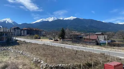 a highway with snow capped mountains in the background at Snow Lodge Mountain view in Bansko