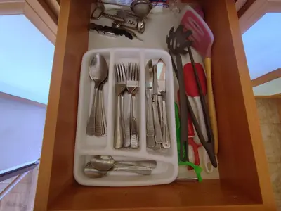 a drawer filled with utensils in a cabinet at Snow Lodge Mountain view in Bansko