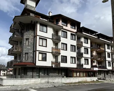 a building with balconies on the side of it at Snow Lodge Mountain view in Bansko