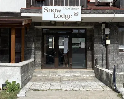 a snow lobby lodge with a sign on the door at Snow Lodge Mountain view in Bansko