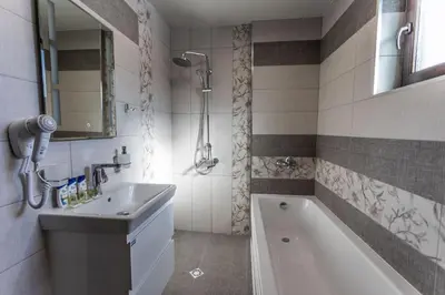 a bathroom with a tub and a sink and a shower at Никонел in Oborishte