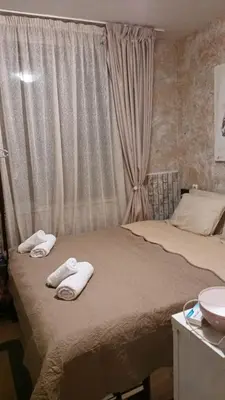 two towels on a bed in a bedroom with a sink at APARTAMENT-DAMO in Pamporovo