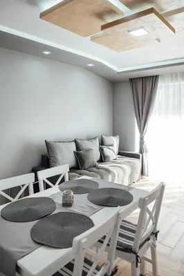 a living room with a table and a couch at Къща за гости Давиос in Sapareva Banya