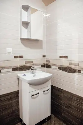 a white bathroom with a sink and a mirror at Къща за гости Давиос in Sapareva Banya