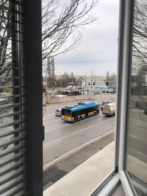 a bus is driving down a street with at Paradise Guest Apartment in Sofia